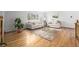 Bright living room featuring hardwood floors, couches, rug, and a plant at 833 Applewood Dr, Lafayette, CO 80026