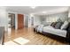 Well-lit main bedroom with warm hardwood floors, a window and multiple closets with doors at 833 Applewood Dr, Lafayette, CO 80026