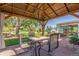 Outdoor patio with covered pergola, stone pavers, and dining set at 833 Applewood Dr, Lafayette, CO 80026