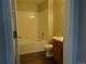 Bright bathroom featuring a shower-tub combo with white tiling and wooden vanity at 3271 E 103Rd Pl # 1308, Thornton, CO 80229