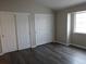 Neutral bedroom featuring wood-look flooring and double closets at 3271 E 103Rd Pl # 1308, Thornton, CO 80229