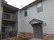 Two-story home featuring stone accents, gray siding, an entrance awning and balcony at 3271 E 103Rd Pl # 1308, Thornton, CO 80229