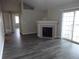 Bright living room with wood-look flooring, fireplace, and sliding glass doors at 3271 E 103Rd Pl # 1308, Thornton, CO 80229