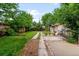 Expansive backyard with green lawn, garden bed, and convenient pathway at 4955 Julian St, Denver, CO 80221