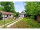 Lush backyard featuring a pathway and detached garage at 4955 Julian St, Denver, CO 80221