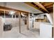 Unfinished basement offering ample storage or potential for customization, with exposed beams at 4955 Julian St, Denver, CO 80221