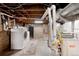 Spacious basement laundry area with washer, dryer, and exposed utilities at 4955 Julian St, Denver, CO 80221