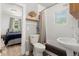Neat bathroom with bathtub, pedestal sink, and a view to an adjacent bedroom for added convenience at 4955 Julian St, Denver, CO 80221