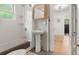 Cozy bathroom featuring a pedestal sink, bathtub, and a stylish mirror, plus lots of light at 4955 Julian St, Denver, CO 80221