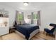 Comfortable bedroom with ample natural light, a cozy bed, and a stylish accent chair at 4955 Julian St, Denver, CO 80221