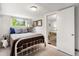 Quaint bedroom with natural light, a comfortable bed, and a view into the dining room at 4955 Julian St, Denver, CO 80221
