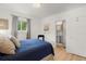 Well-lit bedroom with a view to the bathroom with generous closet space and natural lighting at 4955 Julian St, Denver, CO 80221