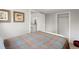 Cozy bedroom featuring a colorful bedspread, closet, and a bright window view at 4955 Julian St, Denver, CO 80221