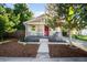 Charming single-story home with a cozy front porch and inviting curb appeal with lawn and walkway at 4955 Julian St, Denver, CO 80221