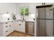 Bright kitchen with white cabinets, stainless steel appliances, and a window view at 4955 Julian St, Denver, CO 80221
