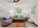 Bright living room features hardwood floors, neutral paint, modern furnishings, and lots of natural light at 4955 Julian St, Denver, CO 80221