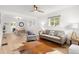 Bright living room features hardwood floors, neutral paint, modern furnishings, and lots of natural light at 4955 Julian St, Denver, CO 80221