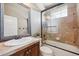 Bathroom with a bathtub shower combination, vanity sink, and framed mirror at 7814 Inverness Blvd, Englewood, CO 80112