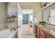 Serene bathroom view to the primary bedroom, soaking tub, and elegant vanity at 7814 Inverness Blvd, Englewood, CO 80112