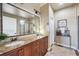 Luxurious bathroom featuring double sinks, granite counters, and a glass-enclosed shower at 7814 Inverness Blvd, Englewood, CO 80112