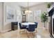 Bright dining room featuring modern lighting, plantation shutters, and stylish blue chairs at 7814 Inverness Blvd, Englewood, CO 80112