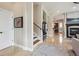 Welcoming entryway featuring tile floors, stairs to the second level, and an open view to the living space at 7814 Inverness Blvd, Englewood, CO 80112