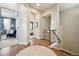 Inviting hallway entrance leading to a cozy sitting area and a glimpse into a bedroom at 7814 Inverness Blvd, Englewood, CO 80112