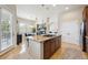 Spacious kitchen with an island cooktop, hardwood cabinets, and an open layout to living areas at 7814 Inverness Blvd, Englewood, CO 80112