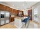 Modern kitchen featuring a large island with seating, stainless steel appliances, and custom cabinetry at 7814 Inverness Blvd, Englewood, CO 80112