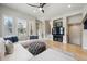 Bright living room with large windows, neutral furnishings, and a ceiling fan at 7814 Inverness Blvd, Englewood, CO 80112
