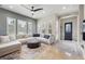 Airy living room with stylish sectional seating, large windows, and decorative wall accents at 7814 Inverness Blvd, Englewood, CO 80112