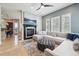 Elegant living room with a cozy fireplace, large windows, and comfortable sectional seating at 7814 Inverness Blvd, Englewood, CO 80112