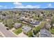 Scenic aerial shot displaying the property nestled among tree-lined streets and mountain views at 7285 S Yukon Ct, Littleton, CO 80128