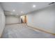 Open basement area with new carpet, recessed lighting and easy access to stairs at 7285 S Yukon Ct, Littleton, CO 80128