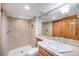 Bathroom featuring a tiled shower and updated vanity with a modern sink at 7285 S Yukon Ct, Littleton, CO 80128