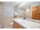 Bathroom with a white sink, tile countertops, and tiled shower with a niche at 7285 S Yukon Ct, Littleton, CO 80128