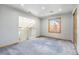 Bright bedroom features gray carpet, neutral walls, and a window with natural light at 7285 S Yukon Ct, Littleton, CO 80128