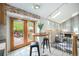 Bright breakfast nook features tile floors, table with seating, and french doors to deck at 7285 S Yukon Ct, Littleton, CO 80128