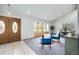 Bright entryway featuring elegant double doors, plush blue seating, and a cozy window seat with natural light at 7285 S Yukon Ct, Littleton, CO 80128