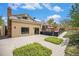Exterior shot with a deck and patio with lush landscaping surrounding the home at 7285 S Yukon Ct, Littleton, CO 80128