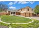 Charming two-story home with manicured lawn, showcasing classic architecture and an attached two-car garage at 7285 S Yukon Ct, Littleton, CO 80128