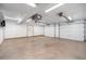 Spacious garage with two doors, ample lighting, and a utility door to outside at 7285 S Yukon Ct, Littleton, CO 80128