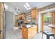 Bright kitchen featuring wooden cabinets, stainless steel appliances, and a center island with a granite countertop at 7285 S Yukon Ct, Littleton, CO 80128