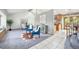 Open-concept living area featuring skylights, plush seating, and seamless flow to the dining and kitchen areas at 7285 S Yukon Ct, Littleton, CO 80128
