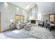 Bright living room with vaulted ceilings, fireplace, and large windows for natural light at 7285 S Yukon Ct, Littleton, CO 80128
