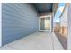 Concrete patio with wood-paneled exterior wall and view of fenced yard at 8836 Waco Ct, Commerce City, CO 80022