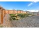 A large back yard features a wooden fence and a stone area at 8836 Waco Ct, Commerce City, CO 80022