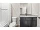 Modern bathroom with a shower-tub combo, sleek vanity, and granite countertops at 8836 Waco Ct, Commerce City, CO 80022