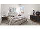 Stylishly staged bedroom with a large window allowing for plenty of natural light and modern design at 8836 Waco Ct, Commerce City, CO 80022