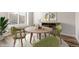 Staged dining area featuring a round wooden table and modern artwork at 8836 Waco Ct, Commerce City, CO 80022